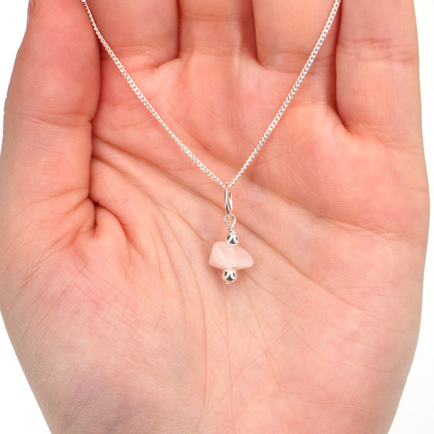 Rose Quartz Gemstone Charm on model for color reference. 