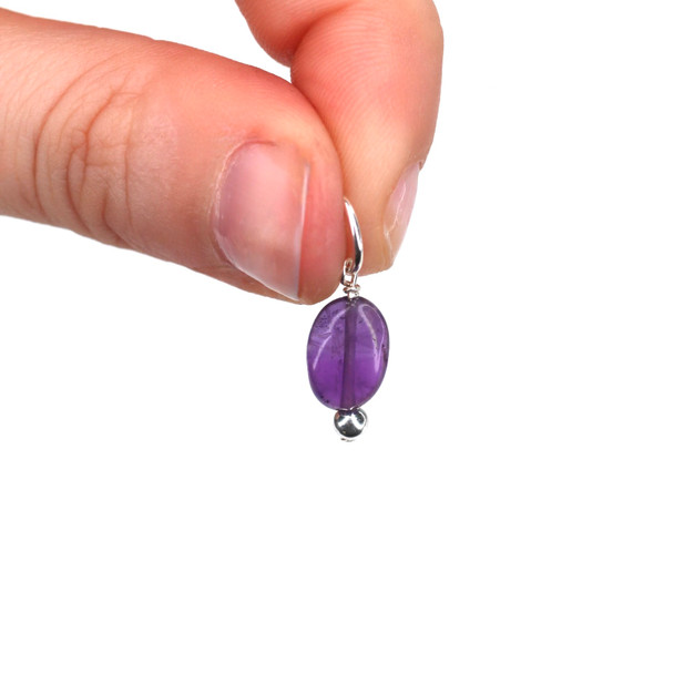 Amethyst Gemstone Charm held to the light