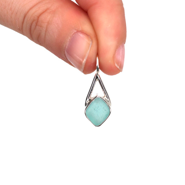Aqua Diamond Sea Glass Lunar Drop Charm held to the light