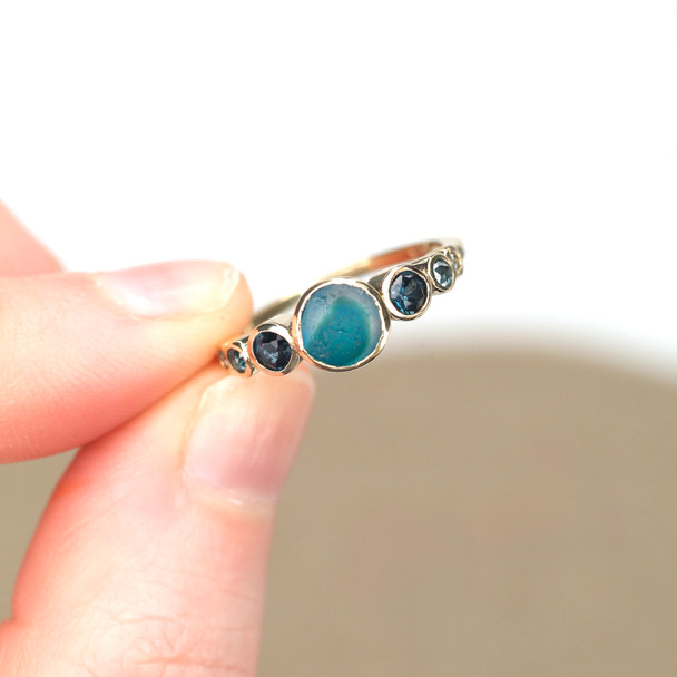Tropical Turquoise Ultra Rare Sea Glass and Gemstone Moon Phases Ring held to the light