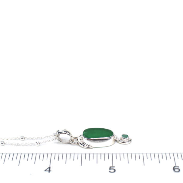 Green Sea Glass and Emerald Swirl Necklace on ruler for size reference.