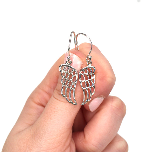 Sterling Silver Angel Wing Earrings on model for color reference.