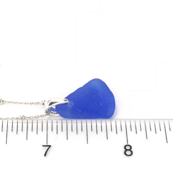 Cobalt Bright Sea Glass Bottle Lip Pinch Necklace on ruler for size reference. 