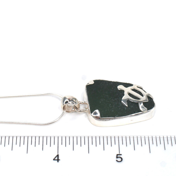 Olive Sea Glass Swimming Turtle Necklace on ruler for size reference. 
