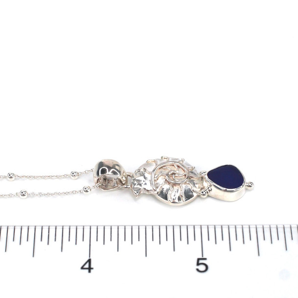 Cobalt Midnight Sea Glass and Silver Nautilus Necklace on ruler for size reference. 
 Cobalt Midnight Sea Glass and Silver Nautilus Necklace on ruler for size reference.