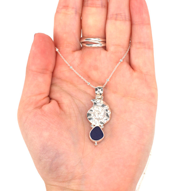 Cobalt Midnight Sea Glass and Silver Nautilus Necklace on model for color reference. 
 Cobalt Midnight Sea Glass and Silver Nautilus Necklace on model for color reference.