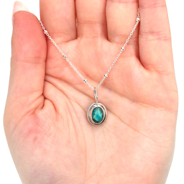 Turquoise Double Bezel Charm on model for color reference. 