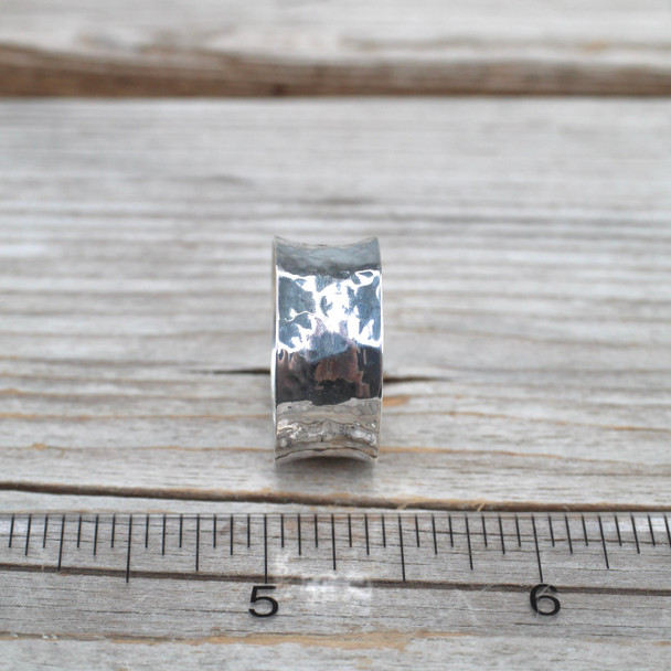 Silver Hammered Wide Band Ring on ruler