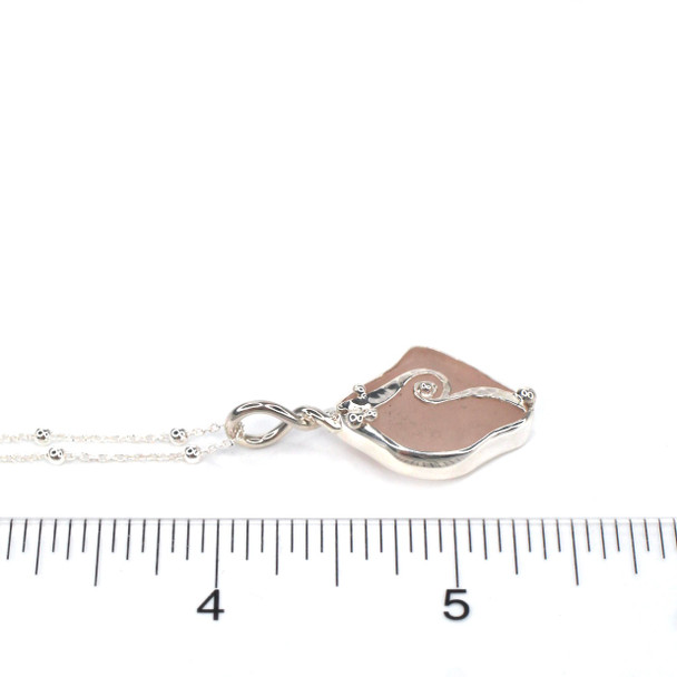 Pink Sea Glass Wave Necklace on ruler for size reference. 