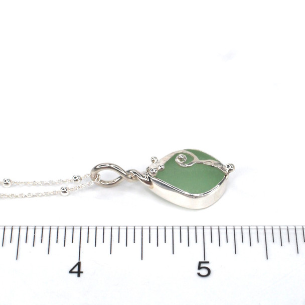 Seafoam Bright Sea Glass Wave Necklace on ruler for size reference. 

