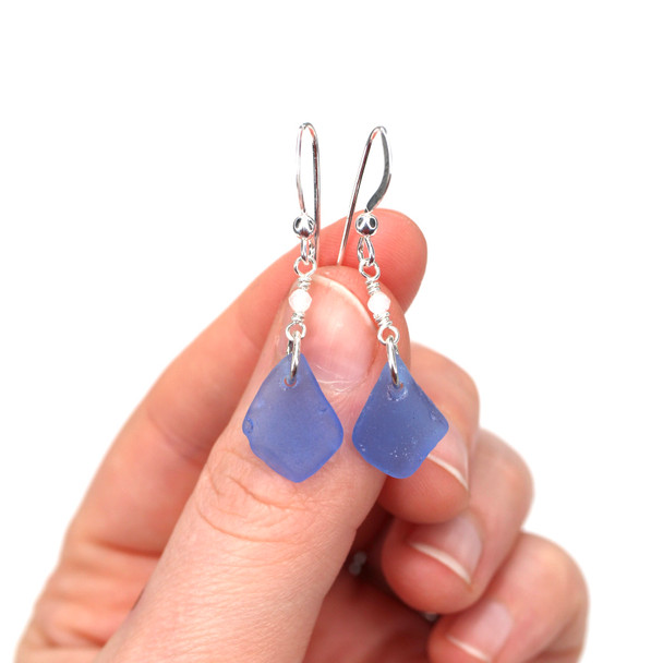 Cornflower Medium Sea Glass and Rainbow Moonstone Gemstone Drop Earrings on model for color reference.