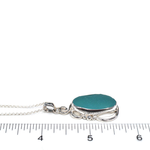 Aqua Sea Glass Tidal Glow Pendant on ruler for size reference.