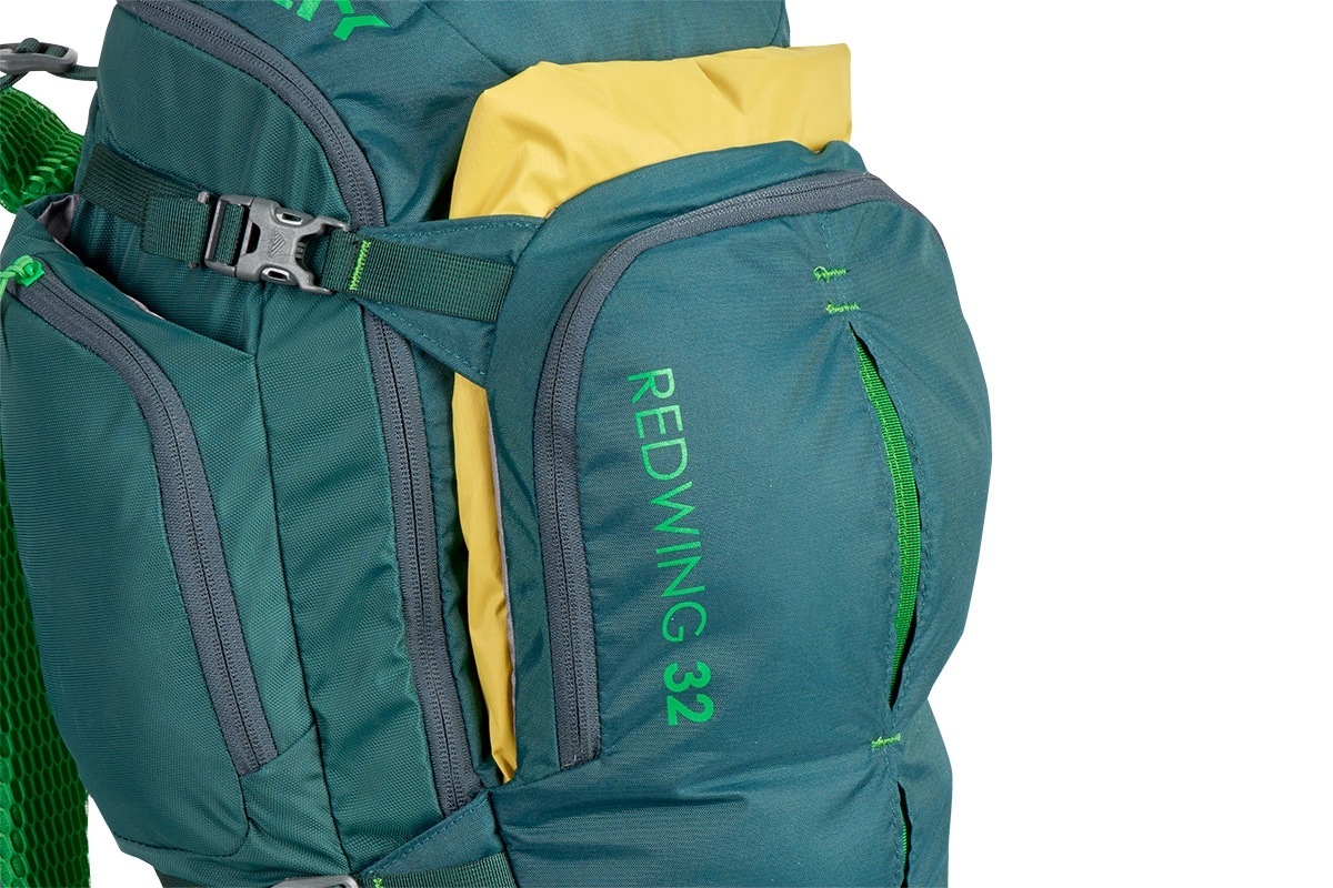 Close up of Kelty Redwing 32 backpack, showing yellow jacket packed in front pocket