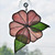 Pink hibiscus with green leaves art glass suncatcher