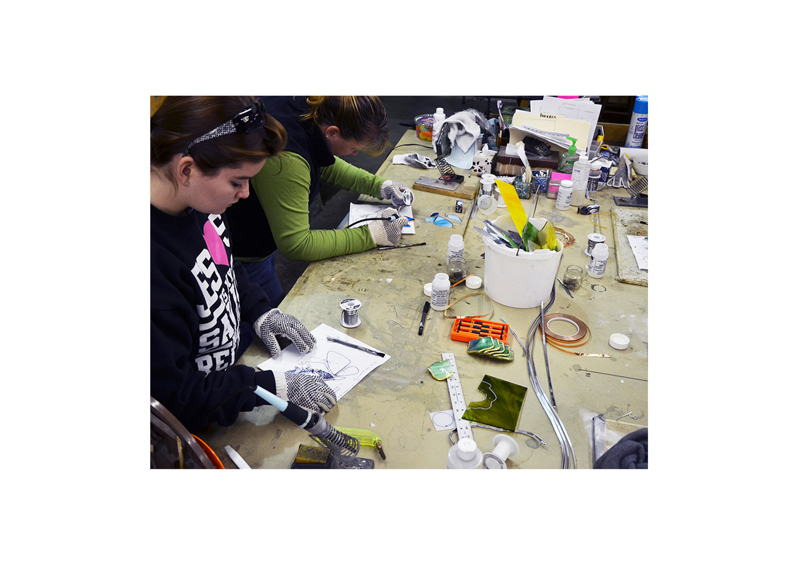 a group of students working on stained glass projects