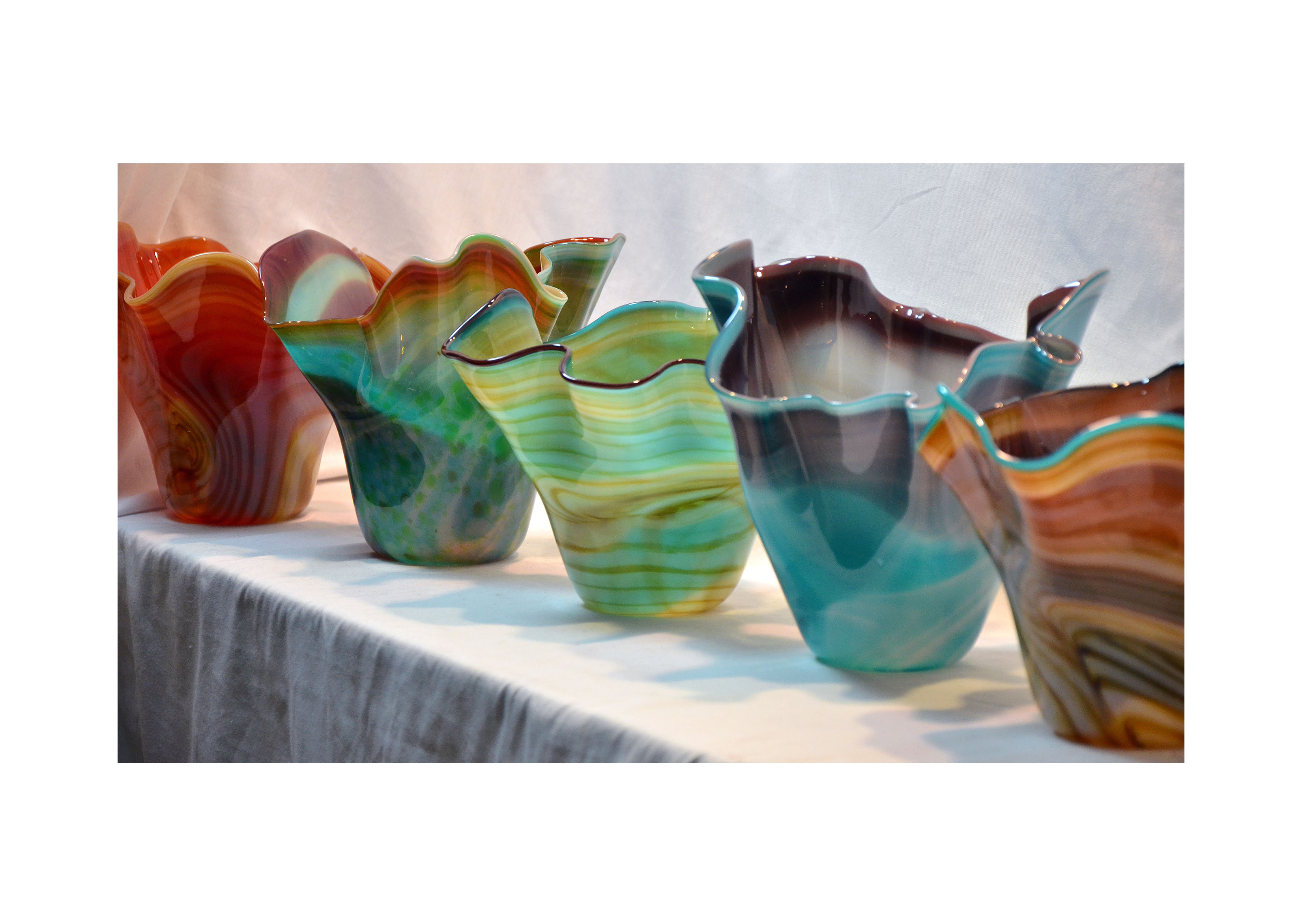 a selection of multi-colored glass bowls
