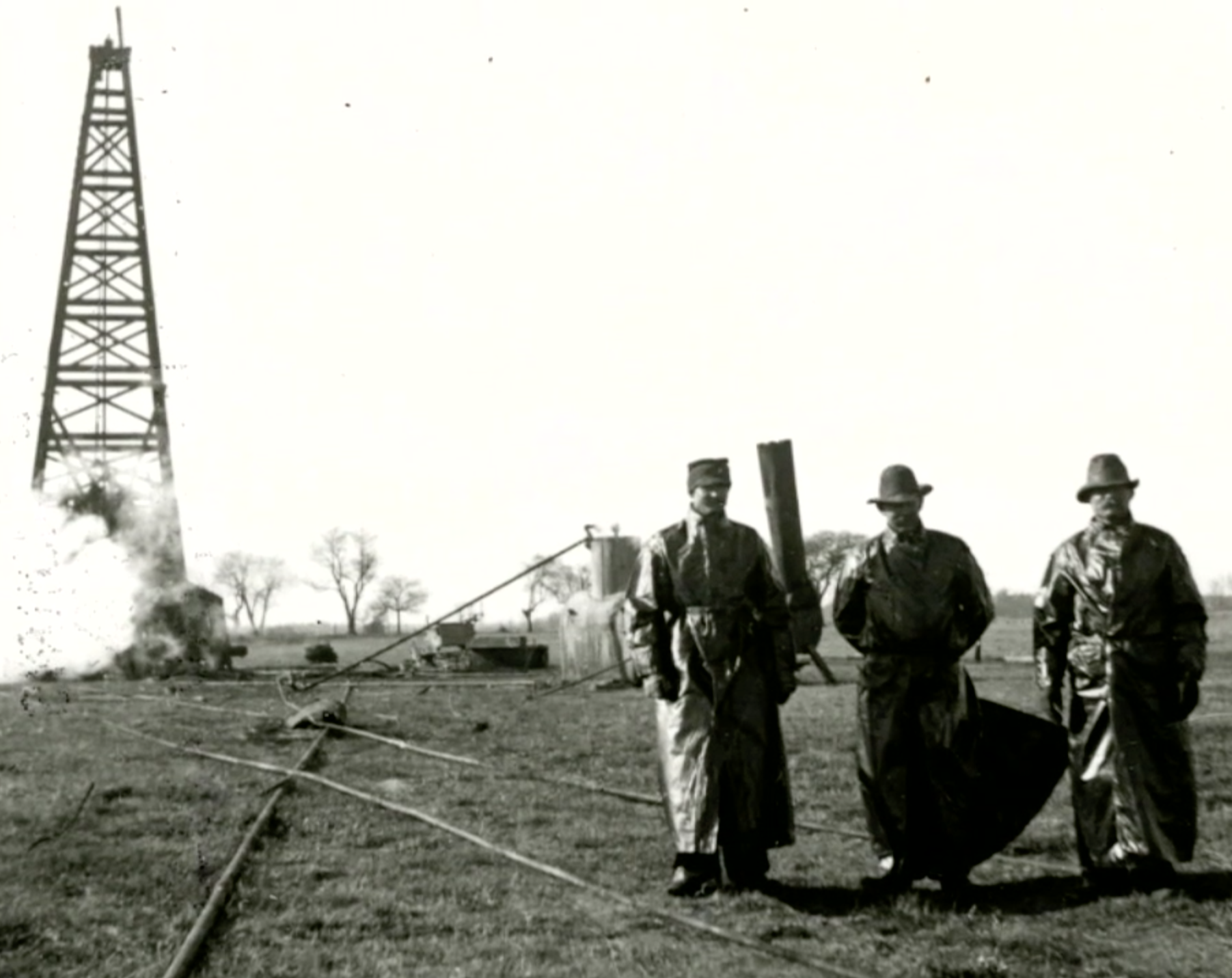 vintage image of men in front of a natural gas well site