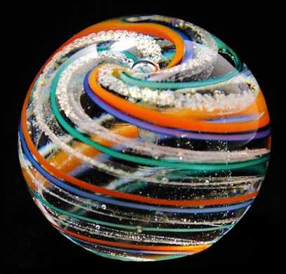 a clear, orange, purple and green glass sphere