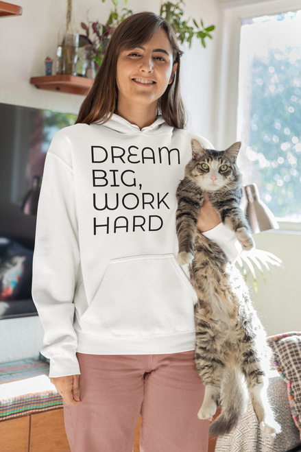 White gildan  pullover  hoodie  mockup  of  a  woman  posing  with  her  cat  at  home with DREAM BIG, WORK HARD