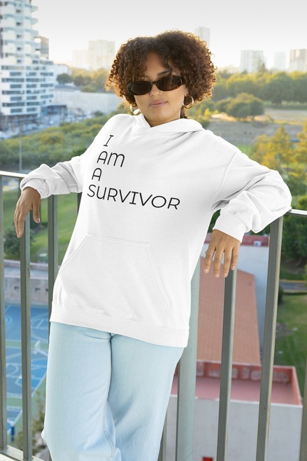 White pullover  hoodie  mockup  of  a  woman  with  curly  hair  wearing  sunglasses  with I AM A SURVIVOR