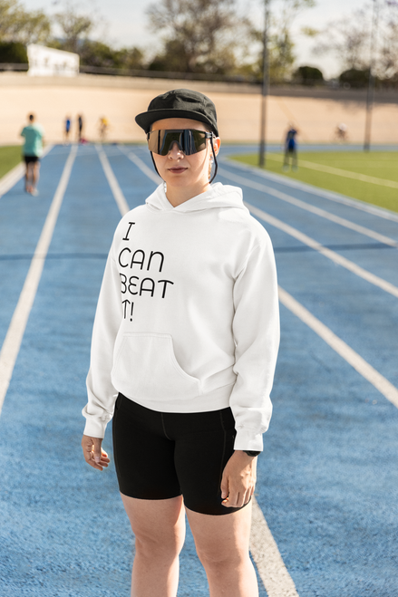 white gildan  hoodie  mockup  of  a  serious  woman  standing  on  a  running  track with I CAN BEAT IT!