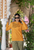 Orange gildan  pullover  hoodie  mockup  of  a  gen  z  woman  standing  with  dark  sunglasses  in  a  balcony DREAM WITHOUT FEAR