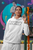 white gildan  hoodie  mockup  of  a  woman  with  a  surprised  expression  looking  up with CELEBRATE YOURSELF