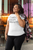 mockup  of  a  smiling  woman  wearing  a  plus  size  white tee  at  a  restaurant with CHASE YOUR DREAMS