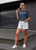 navy t  shirt  mockup  of  a  stylish  woman  in  the  street with BE YOURSELF!