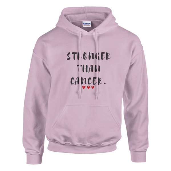 Light pink pullover hoodie displayed against a light gray background. The front features the empowering message “STRONGER THAN CANCER.” in distressed black lettering, accented by three small red hearts beneath the text. The hoodie includes a drawstring hood, kangaroo pocket, and ribbed cuffs and hem. The soft pink color paired with the bold message creates a design that symbolizes strength, hope, resilience, and support for individuals affected by cancer.