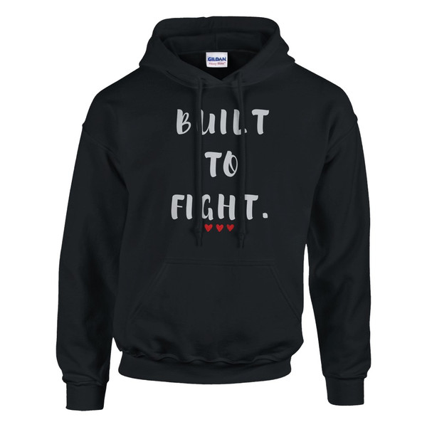 Black pullover hoodie featuring the inspirational quote “Built to Fight” in distressed white lettering with red heart accents, displayed on a plain background.