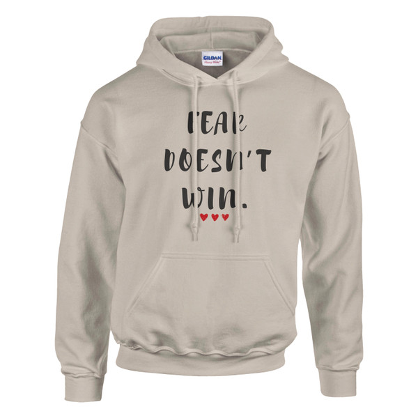Sand-colored hoodie featuring the motivational quote “FEAR DOESN’T WIN” in black lettering with three red hearts, symbolizing courage, resilience, hope, empowerment, mental strength, and overcoming fear.