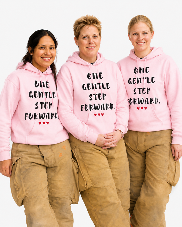 Three firefighter women with pink hoodies featuring inspiring quote "One Gentle Step Forward"