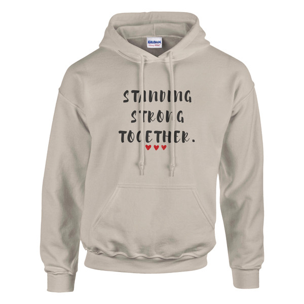 Sand-colored pullover hoodie featuring the inspirational quote “Standing Strong Together” in distressed black lettering with red heart accents, displayed on a plain background.