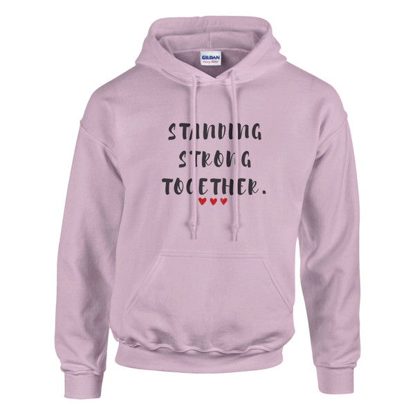 Light pink pullover hoodie featuring the inspirational quote “Standing Strong Together” in distressed black lettering with red heart accents, displayed on a plain background.