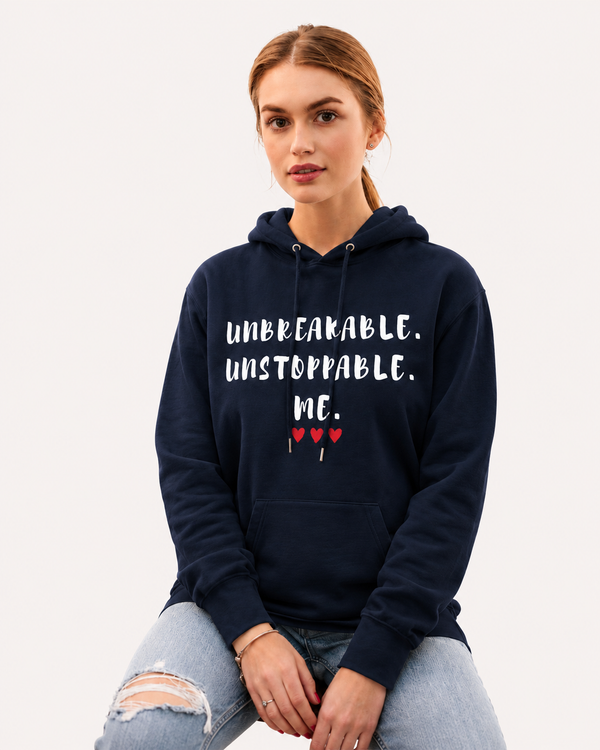 Woman wearing a navy blue hoodie featuring the motivational quote “Unbreakable. Unstoppable. Me.” with red heart accents, inspirational apparel promoting confidence, resilience, determination, and personal empowerment.