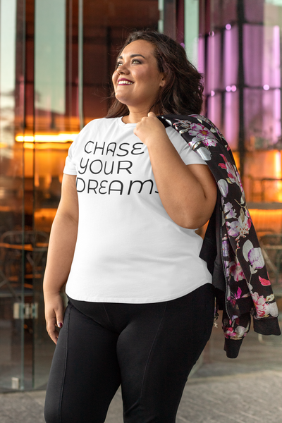 mockup  of  a  smiling  woman  wearing  a  plus  size  white tee  at  a  restaurant with CHASE YOUR DREAMS