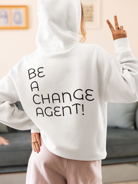 white back view hoodie mockup of a woman in a cozy outfit making a peace sign at home with BE A CHANGE AGENT!