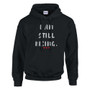 A black hooded sweatshirt displaying the words “I Am Still Rising” in white distressed text, with three small red hearts underneath. The design conveys resilience, strength, and hope.