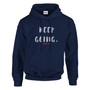 Front-facing product mockup of a navy blue pullover hoodie displayed against a light gray background. The hoodie features the motivational phrase “KEEP GOING.” in distressed white hand-lettered text centered on the chest, with three small red hearts beneath the wording. The design is positioned above the front kangaroo pocket and below the drawstring hood. The hoodie includes long sleeves, ribbed cuffs and waistband, and a classic relaxed fit. The simple, uplifting design conveys perseverance, resilience, determination, and encouragement to keep moving forward.