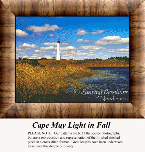 A lighthouse stands tall under blue skies filled with fluffy clouds, surrounded by autumn-colored marshland in this xstitch design.