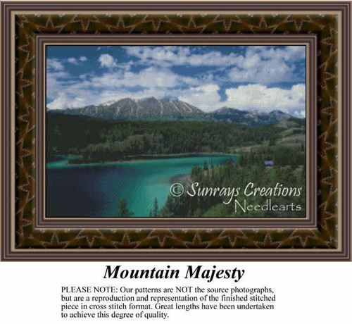 A mountain landscape with a striking backdrop, an emerald lake, and a blue sky with fluffy clouds, designed as a cross stitch design.