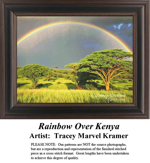 A massive, vibrant rainbow arcs across a stormy grey sky, casting light over a lush green African savanna dotted with acacia trees in a detailed cross-stitch design.