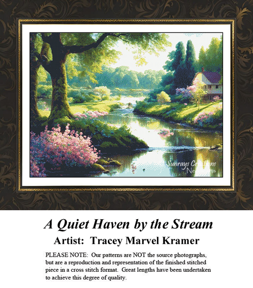 A cozy country cottage sits nestled among lush green trees and blooming pink bushes alongside a calm, reflecting stream in a peaceful pastoral landscape cross-stitch pattern.