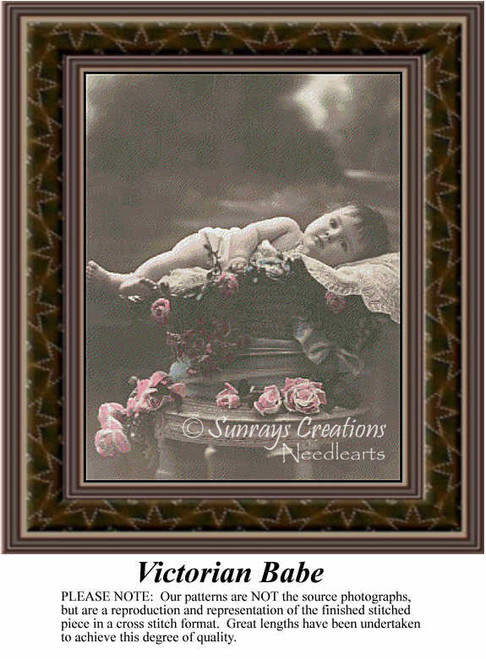 A charming baby girl rests on a lace-covered basket amidst roses, shown in this xstitch pattern by Sunrays Creations with warm sepia tones.