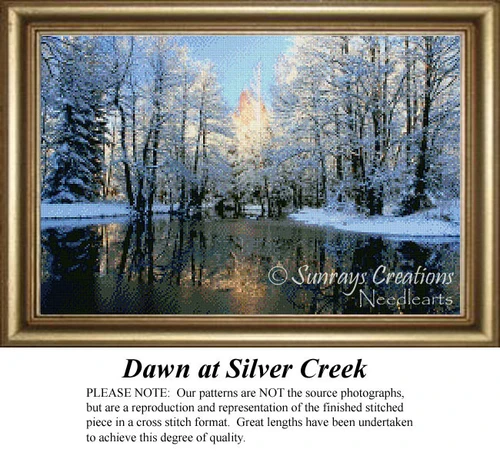 A winter landscape with sunlit trees resembling spun gold, reflected in a serene creek, available as a digital pattern for a cross stitch project.