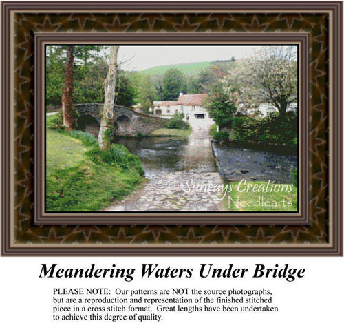 A scenic landscape with a cottage, a gentle stream flowing under a stone bridge, and blossoming trees, designed for a cross stitch project.