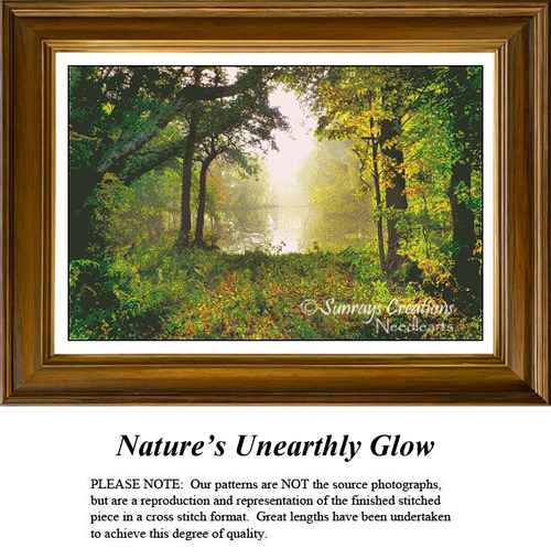 A detailed counted cross-stitch pattern preview showcasing a mystical forest opening bathed in a soft, bright haze. The atmospheric landscape design features dense green and gold autumn trees flanking a clearing that overlooks a misty, sun-drenched lake under an unearthly, luminous glow.