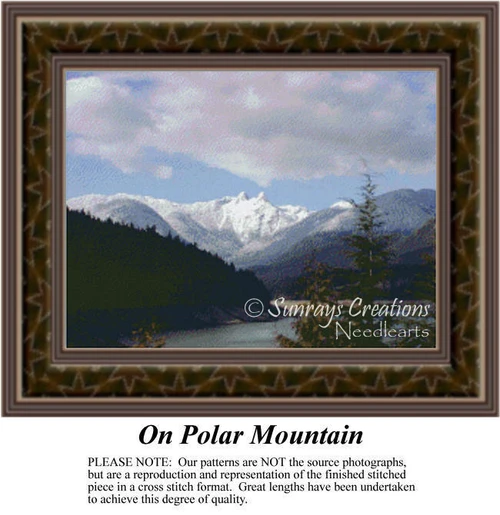 A mountain range rises dramatically under a cloudy sky, surrounded by pine trees, translated into a counted cross stitch design.