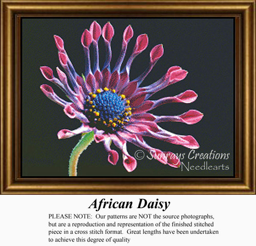 A vibrant flower with spoon-like pink and purple petals and a blue center is captured as a counted cross stitch pattern.